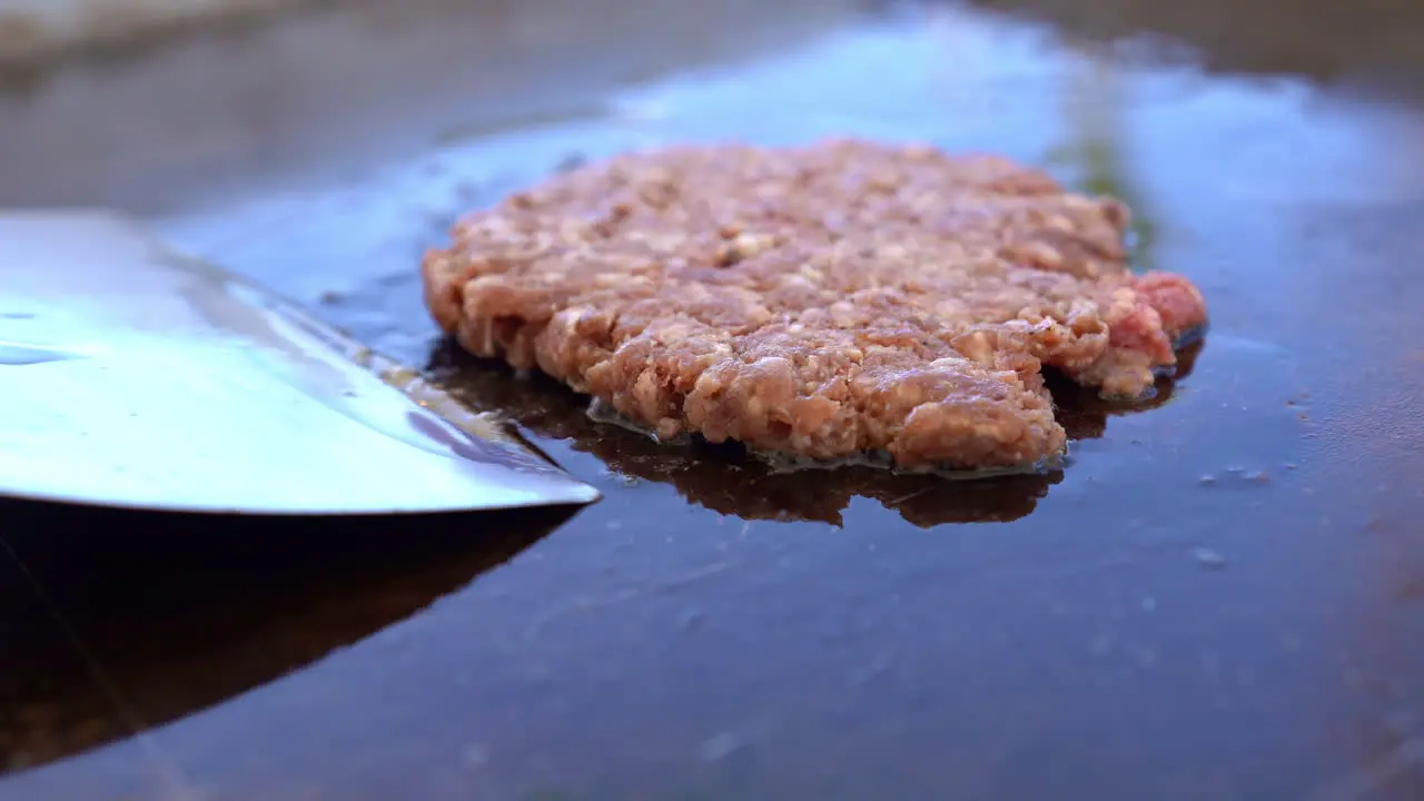 The chef cooks the burger beef on the grill