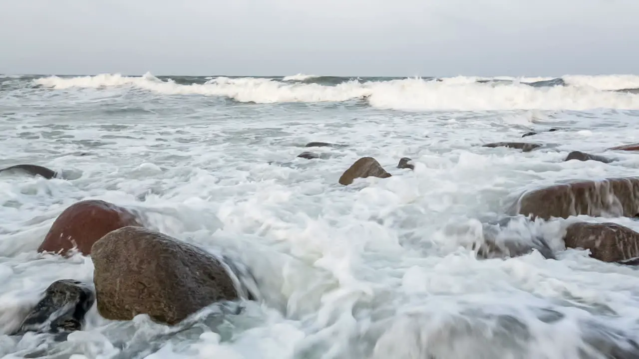 Waves and foam on rocky beach