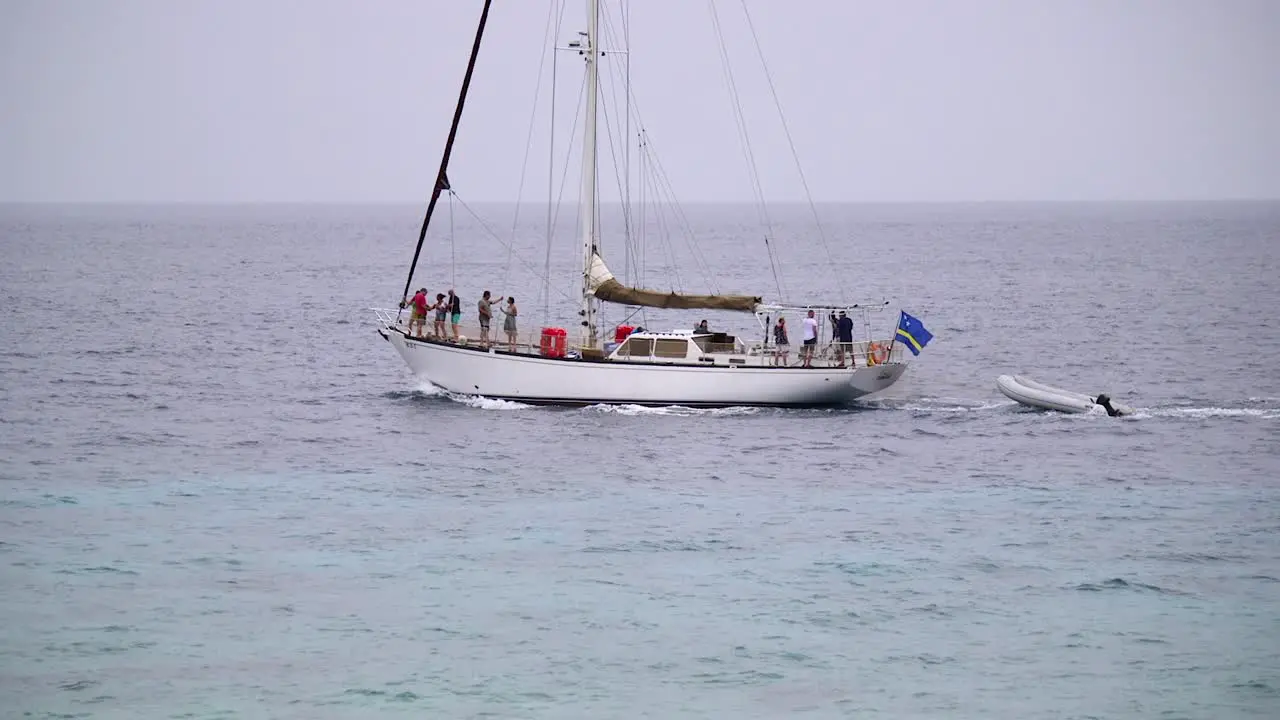 Yacht showing the flag of Curacao sailing across the ocean in the Caribbean