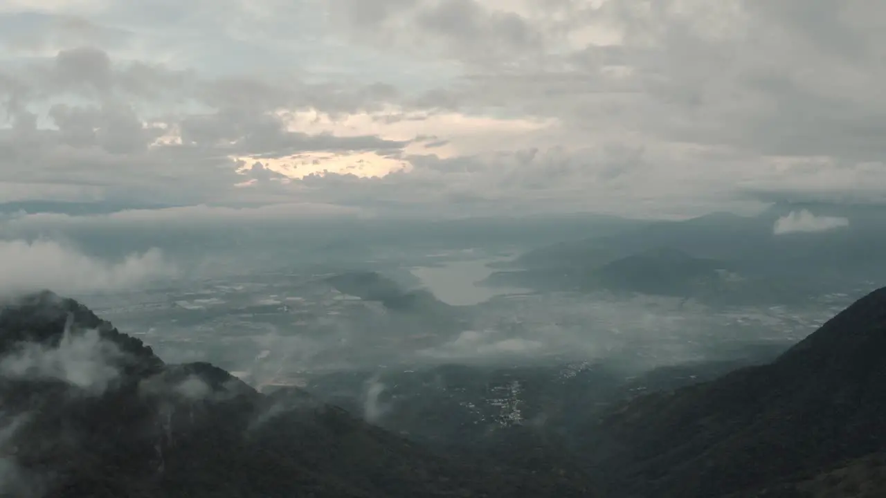 Drone aerial over the clouds view of lake Amatitlan and mountains in Guatemala