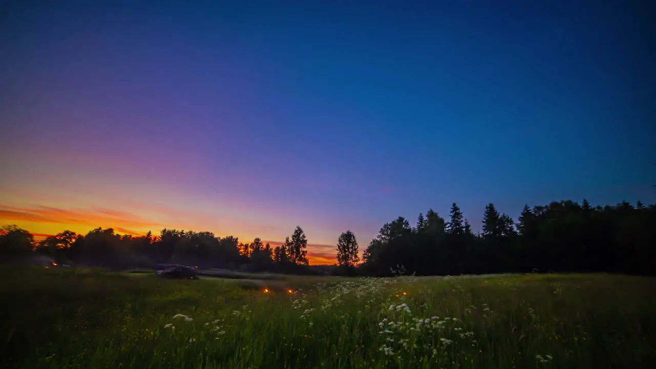 Stunning sunset then bonfires as people enjoy a night in the countryside all night and day time lapse