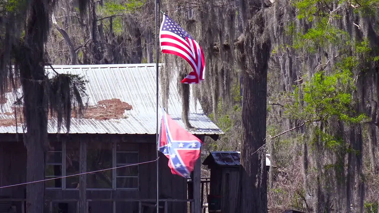 A rundown old bayou house flies a Confederate Flag in rural deep South