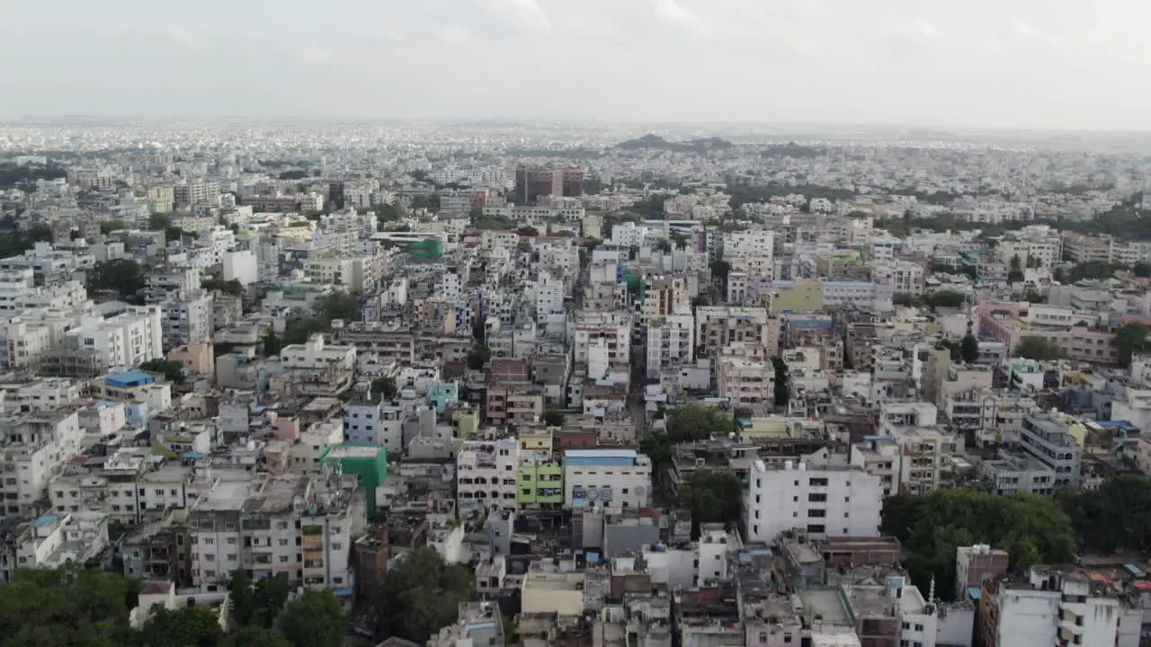 Aerial footage in 4K 60 frames resolution of an Indian city in the morning over a neighborhood