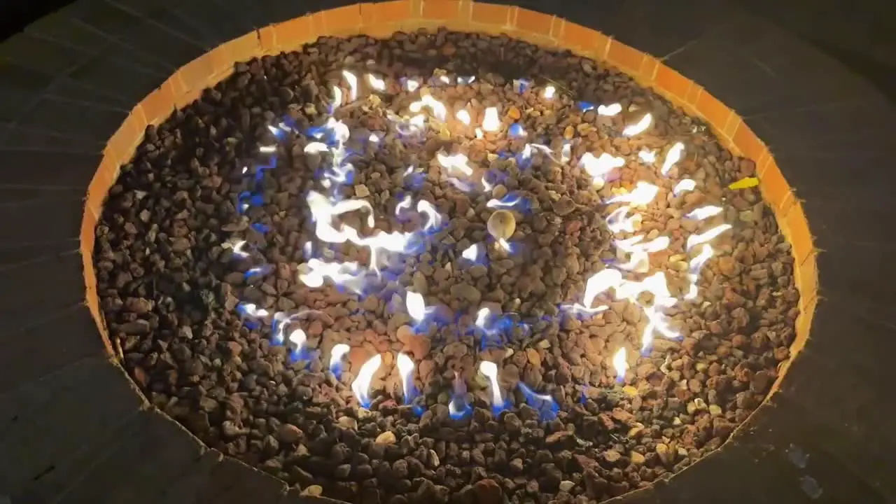 Outdoor backyard firepit with flames in slow motion