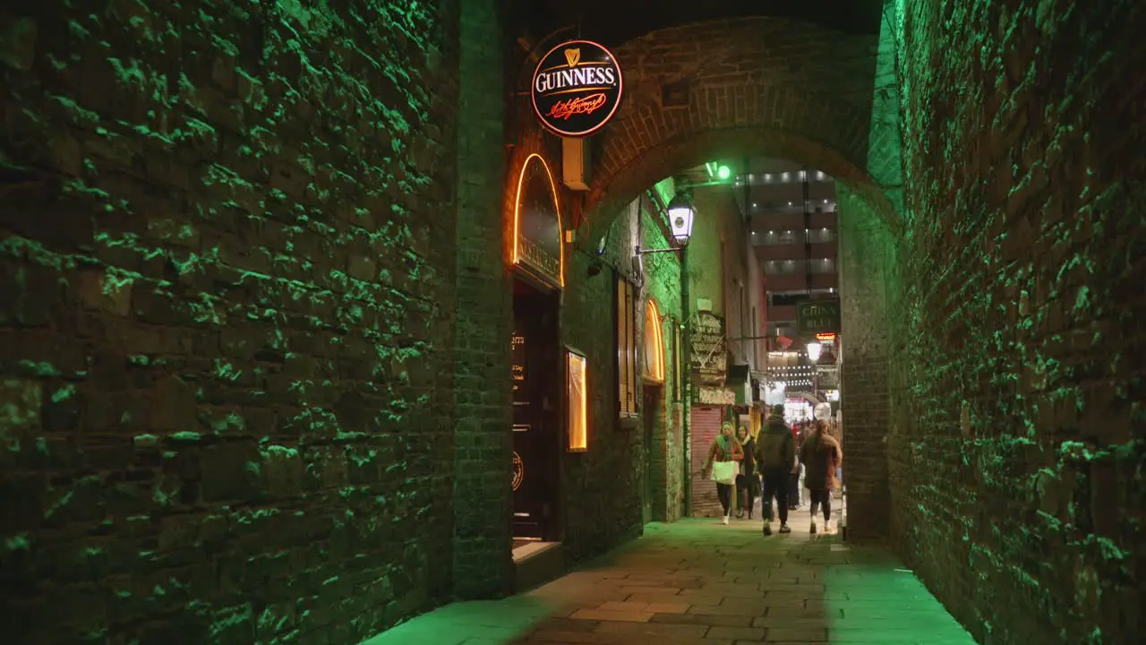 People Walking In The Alley At Merchants Arch At Night In Dublin Ireland