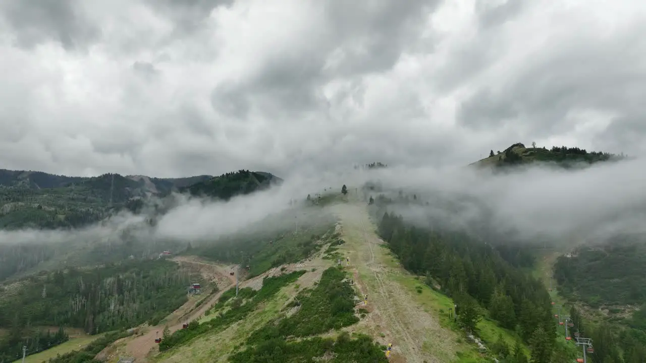 Aerial of low fog hanging over mountain and forest trees-11