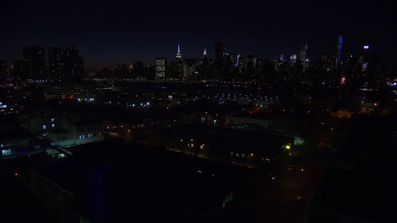 A wide angle view over Queens New York City at dusk with the Manhattan skyline background 2