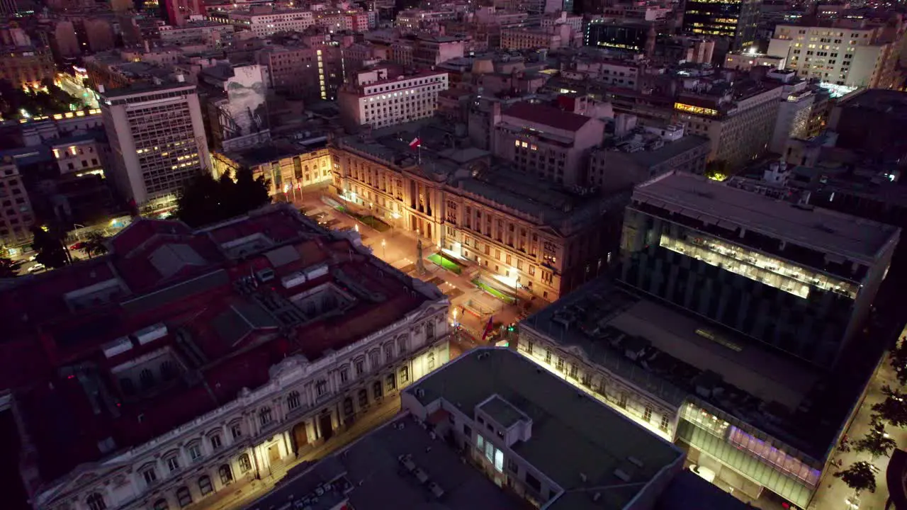 Aerial view approaching Palace of the Courts of Justice of Santiago illuminated historical building exterior at night