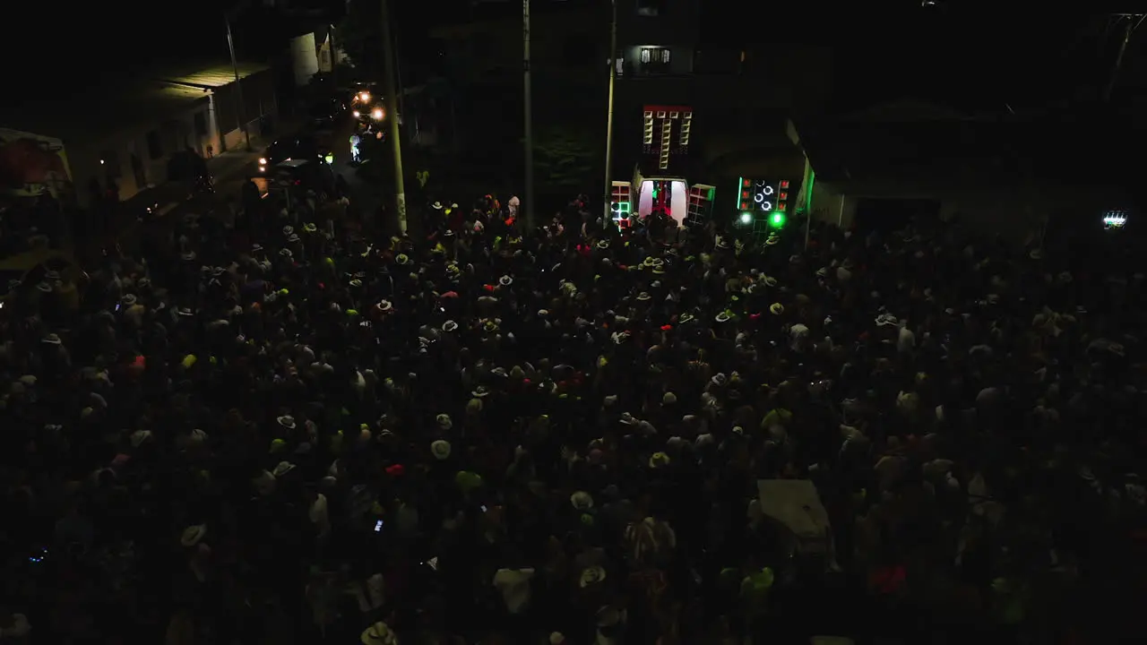 People partying the Carnaval Batalla de Flores on night streets of Barranquilla Colombia Aerial view