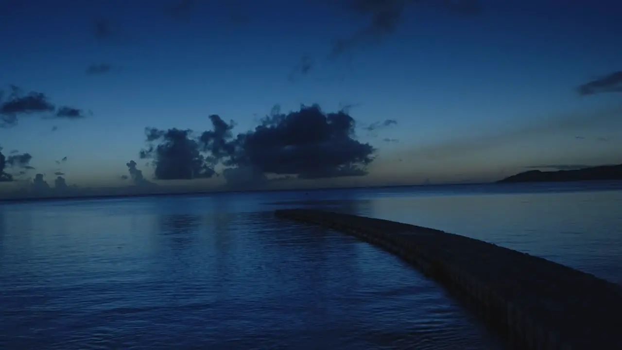 A tranquil night view featuring a floating pier above calm waters