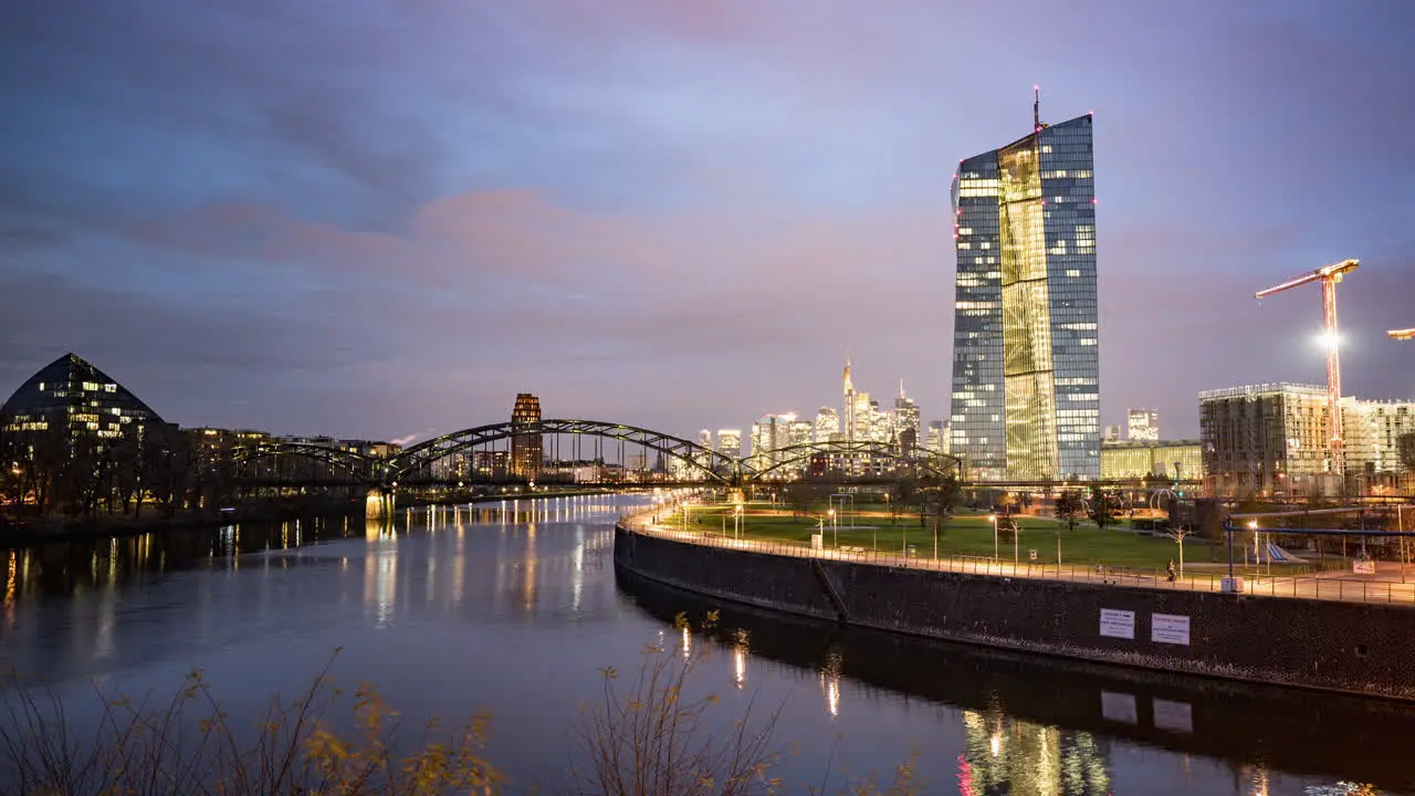 Moving clouds over European Central Bank and Frankfurt city skyline at dawn