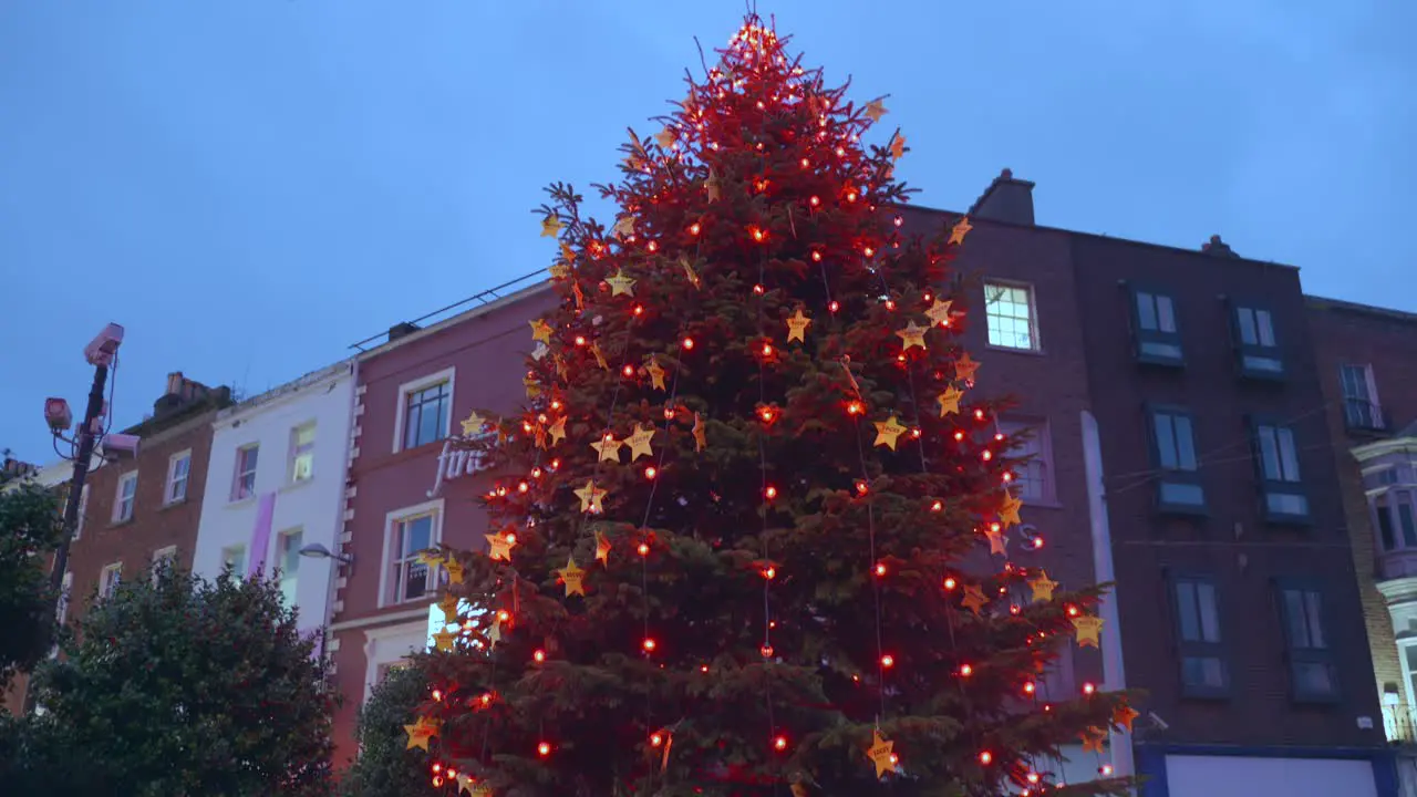 Large decorated christmas tree with red lights in Dublin city center