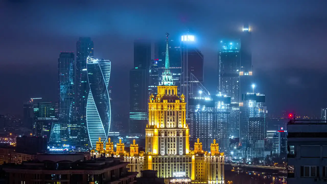 Time lapse of the cloud moving over tall building in the city at night