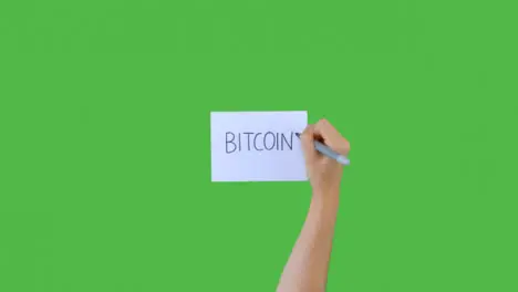 Woman Writing Bitcoin on Paper with Green Screen