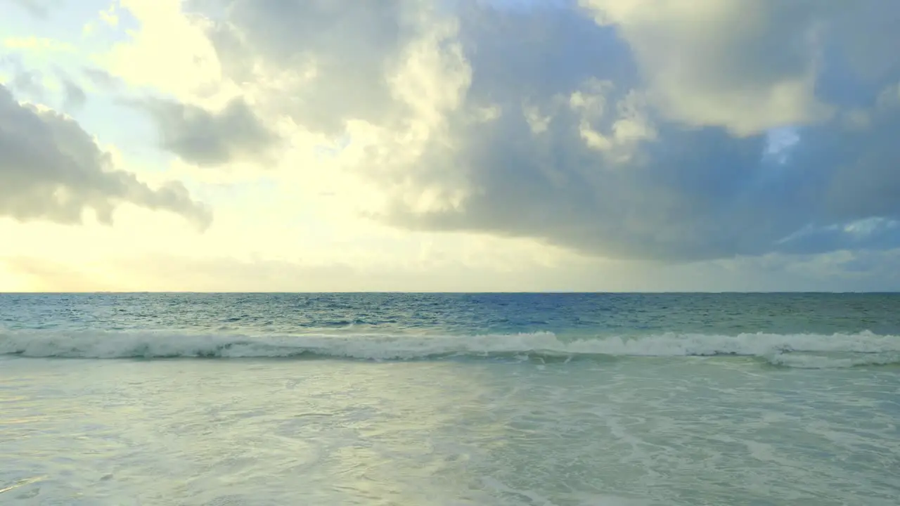 low waves of a calm ocean strand on a lonely deserted sandy beach