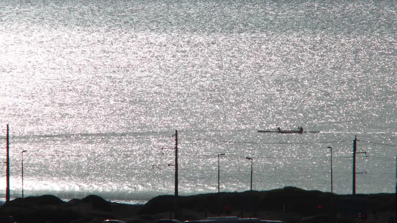 Kayaks rowing along the coast at morning