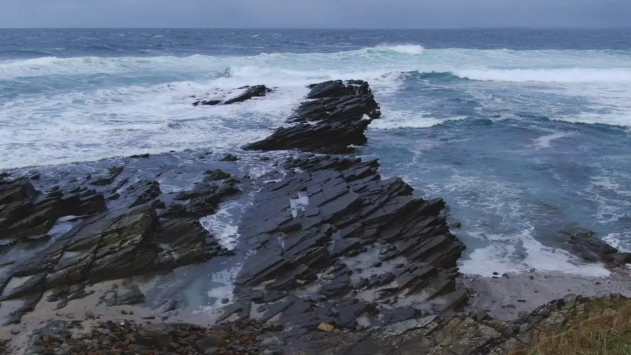 Slow motion aerial shot flying towards crashing waves