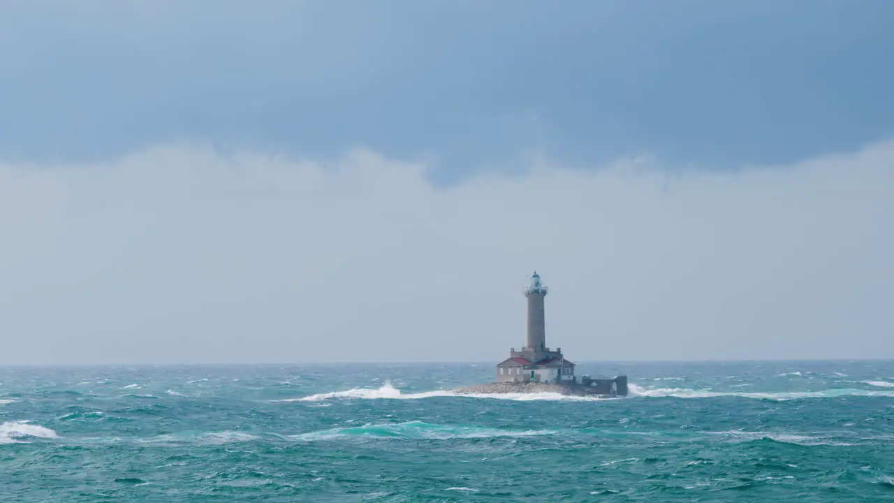 Lighthouse Porer under strong south wind and waves on stormy weather restless sea