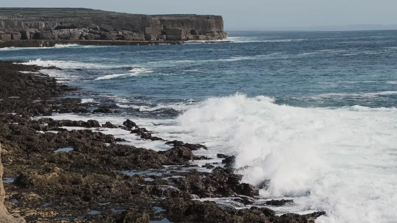 Sea waves crashing on rocky shore of Inishmore island in Ireland