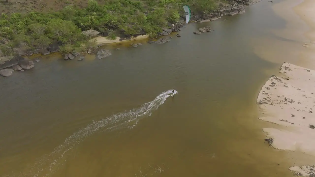 Wind surfer practicing in a small lake next the beach in Sierra Leone Africa