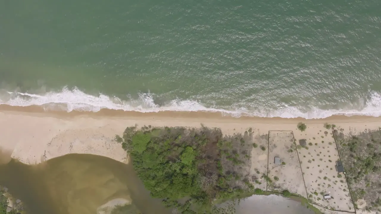 Top down aerial footage of beach and waves in Sierra Leone Africa