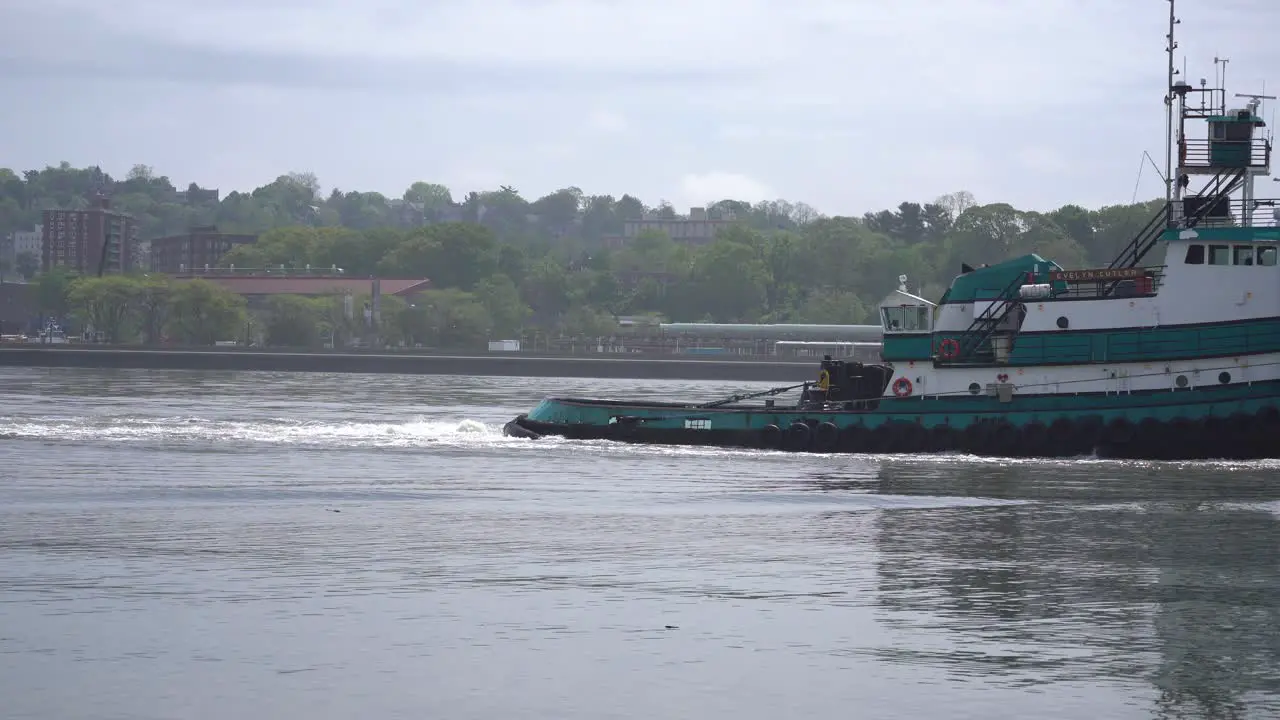 tug boat towing larger ship