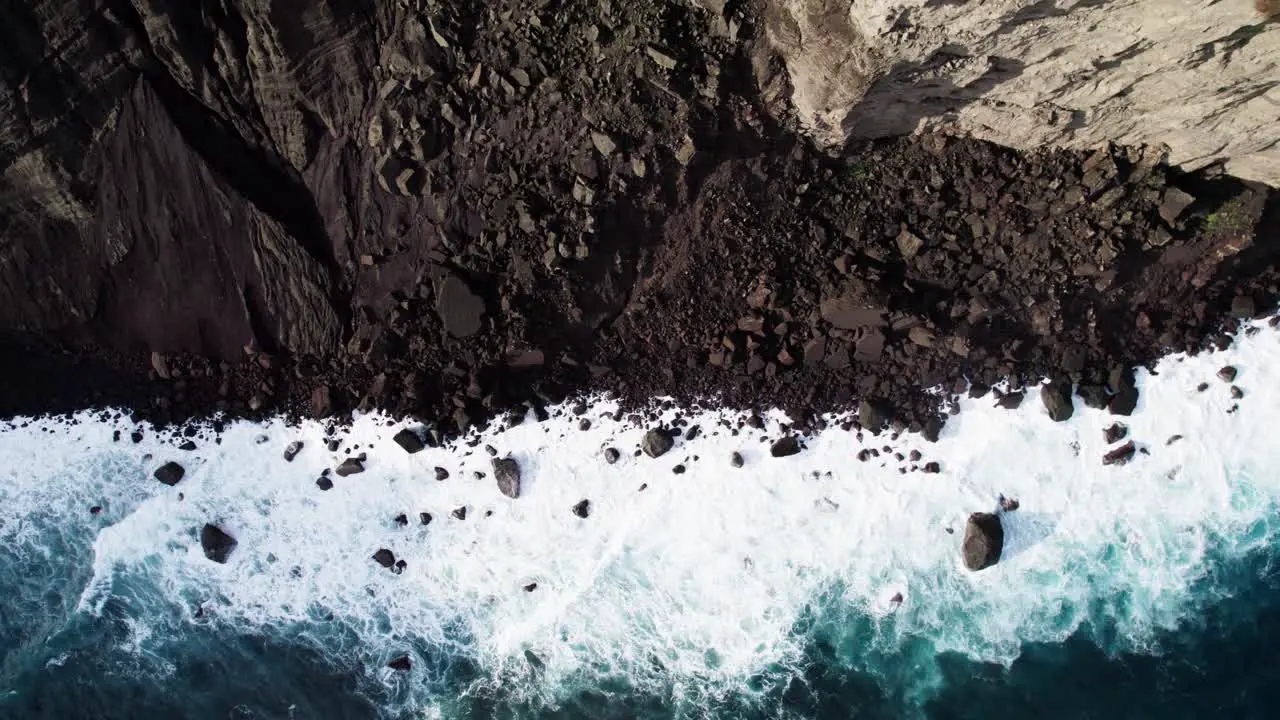 Waves crashing into the rocks on the beach of the Island of Faial in Azores