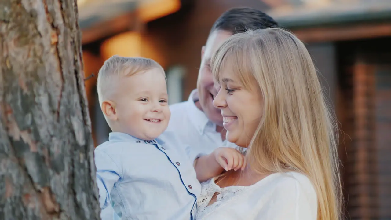 Portrait Of A Young Happy Family Mom Dad And Baby Boy Walking In The Park Slow Motion Video