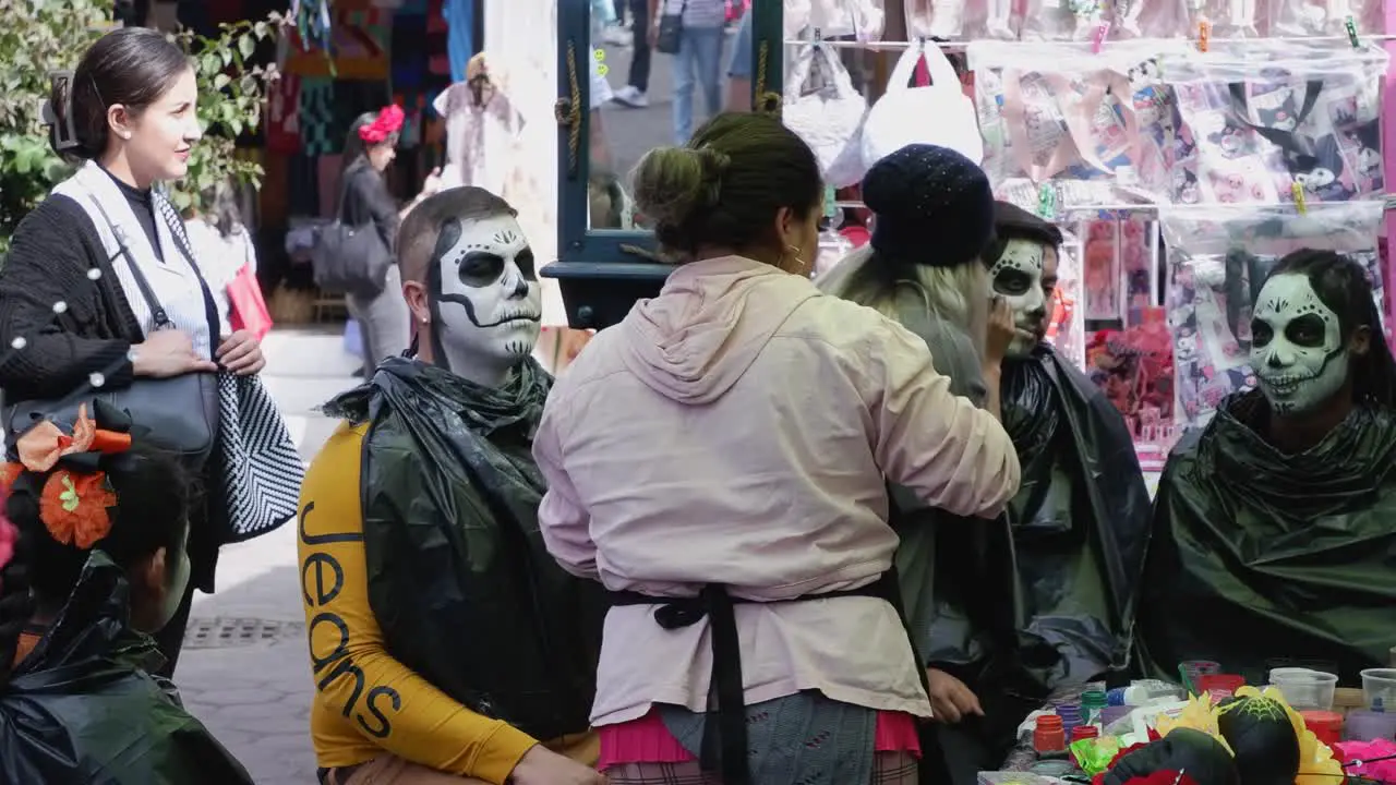 Revelers get skull face paint for Day of the Dead celebration Mexico