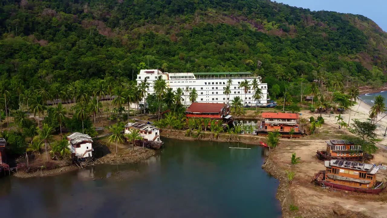 Kayakers kayaking in abandoned Koh Chang lagoon resort with ghost ship