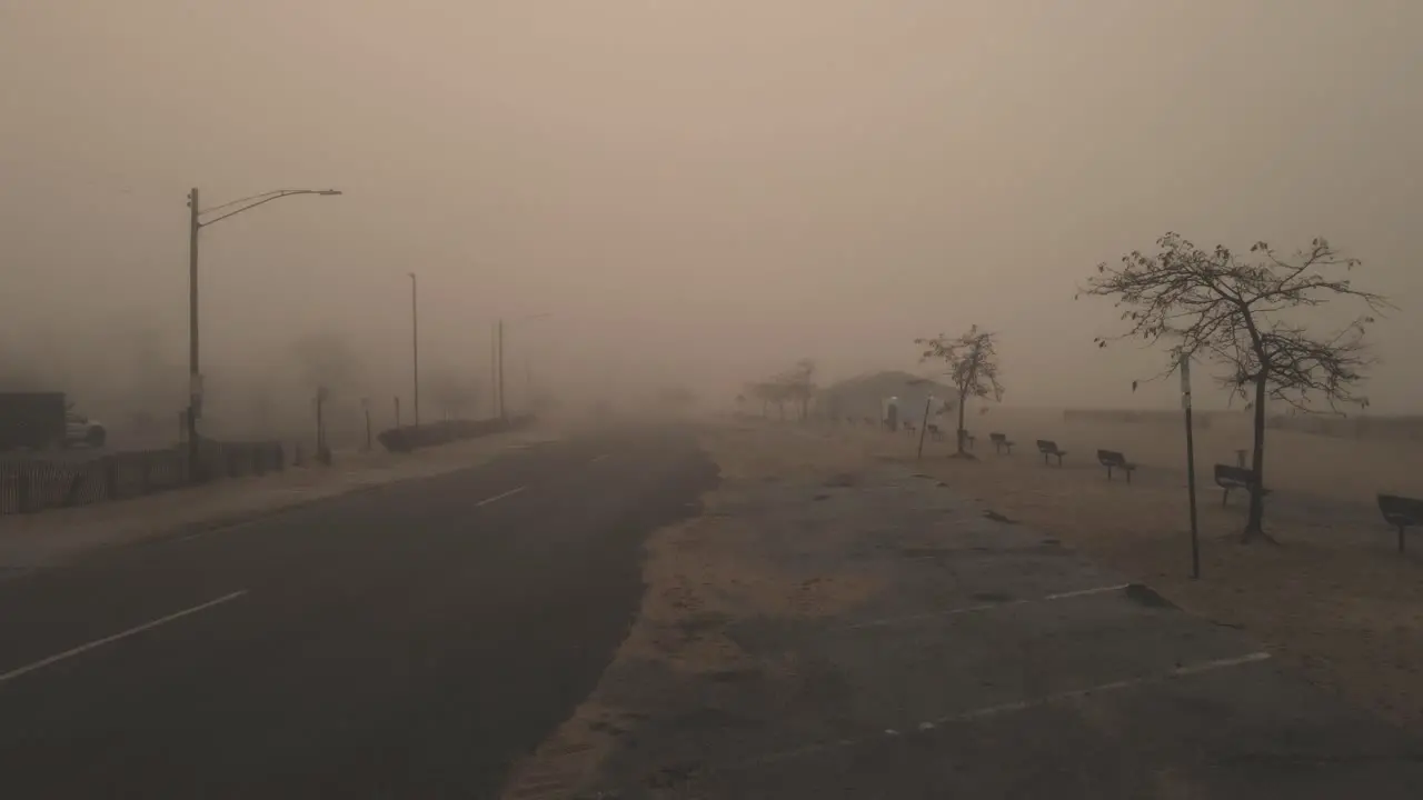 Pushing forward along a sandy street during heavy mist