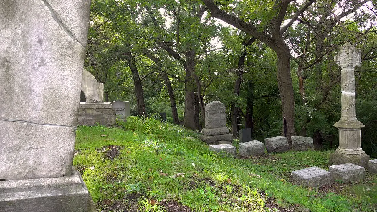 close up of tombstones in very old graveyard panning 4k