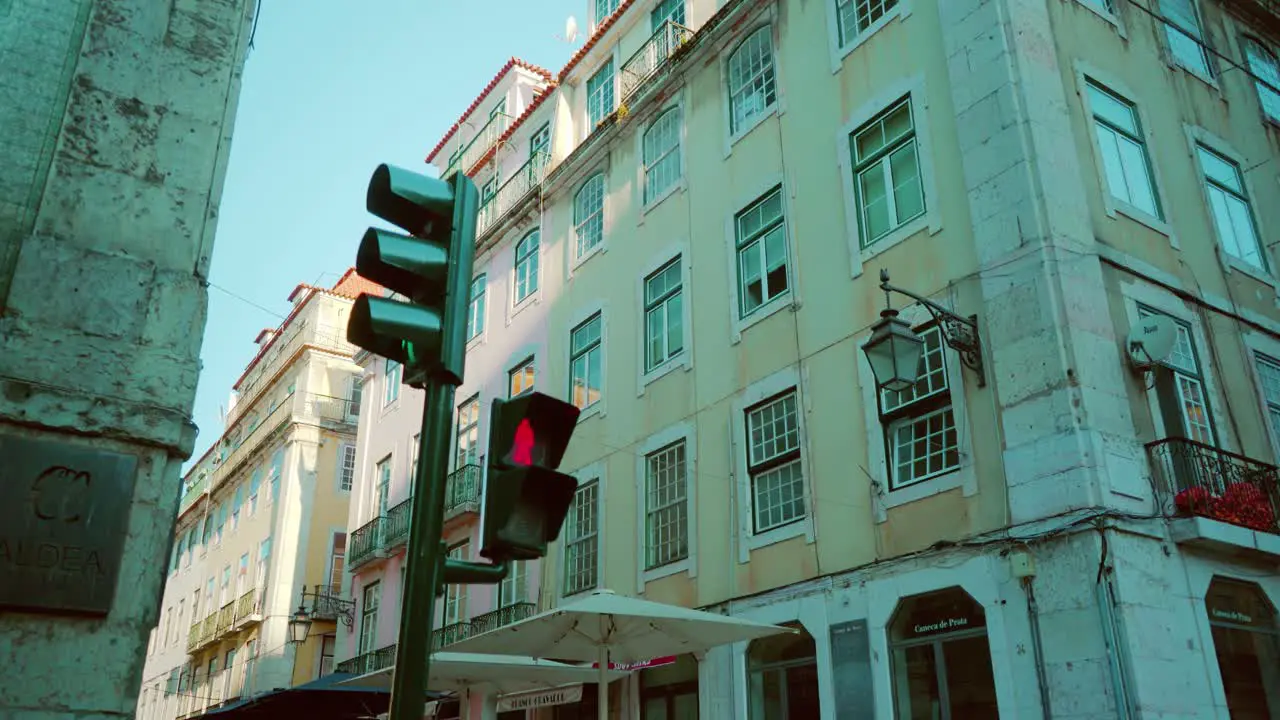 Empty Lisbon city downtown with traffic lights public lamp and old buildings facade during sunrise