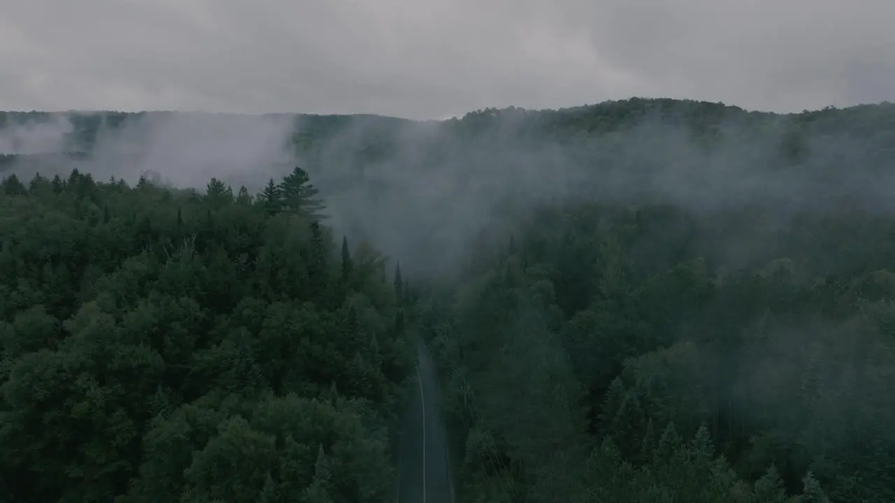 Drone flying through a beautiful foggy mountain top landscape