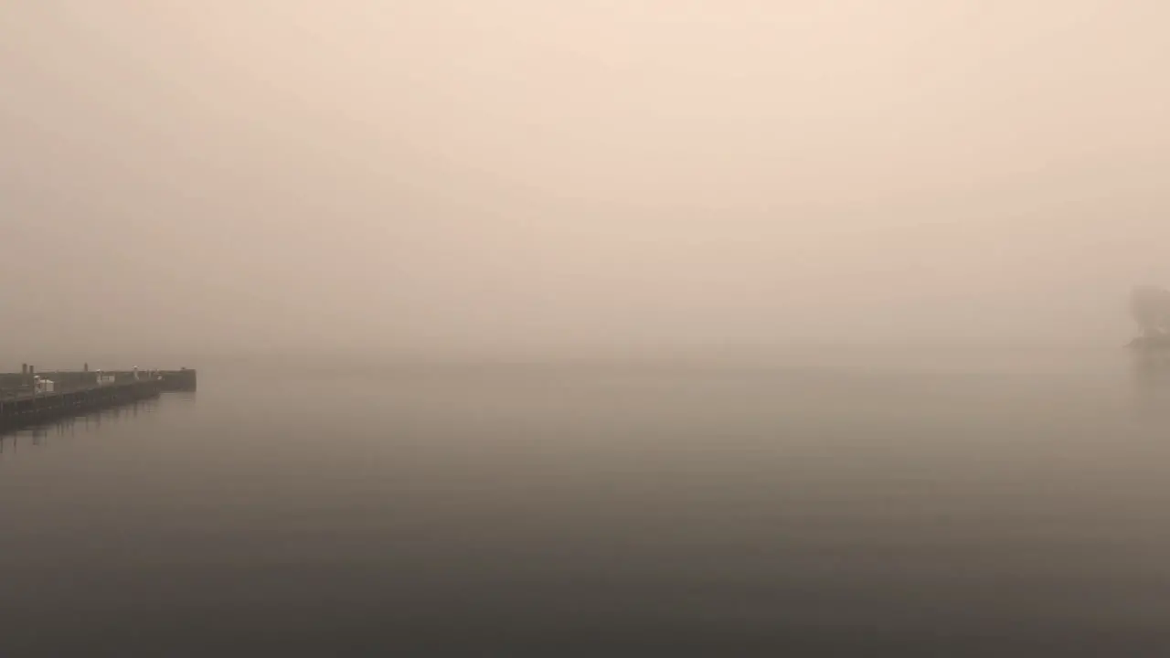 A dock on a misty lake