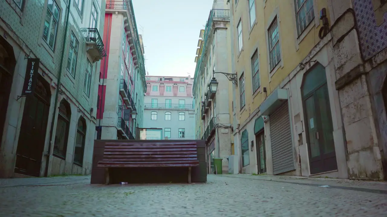 Empty Lisbon city downtown with public bench old buildings facade during covid-19 lockdown at sunrise 4k