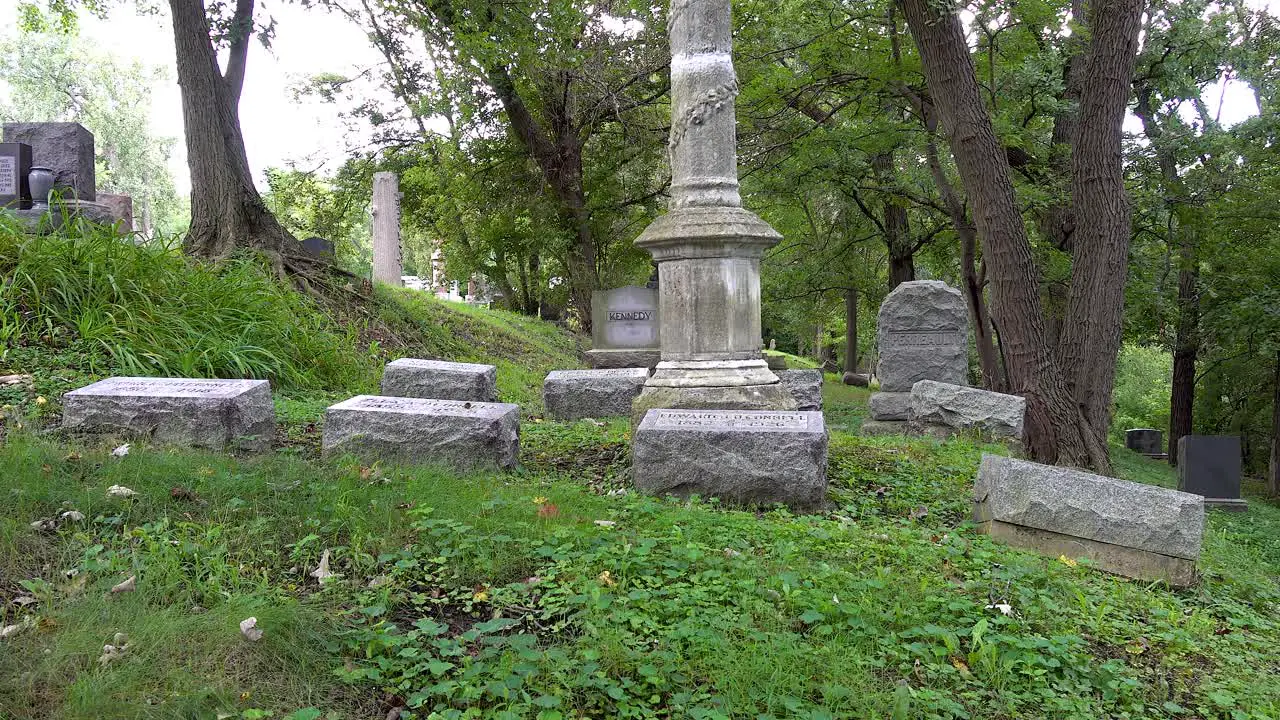 old cemetery panning shot of tombstones in a graveyard with trees 4k