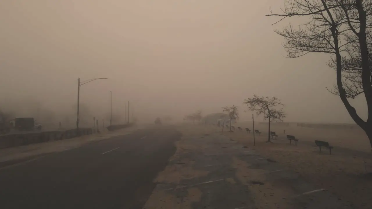 Mist lightly flowing over a street during a cold October morning