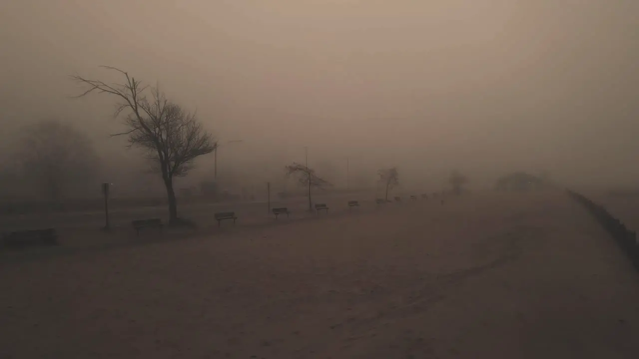 Reverse motion pulling away from a creepy mist covered beach