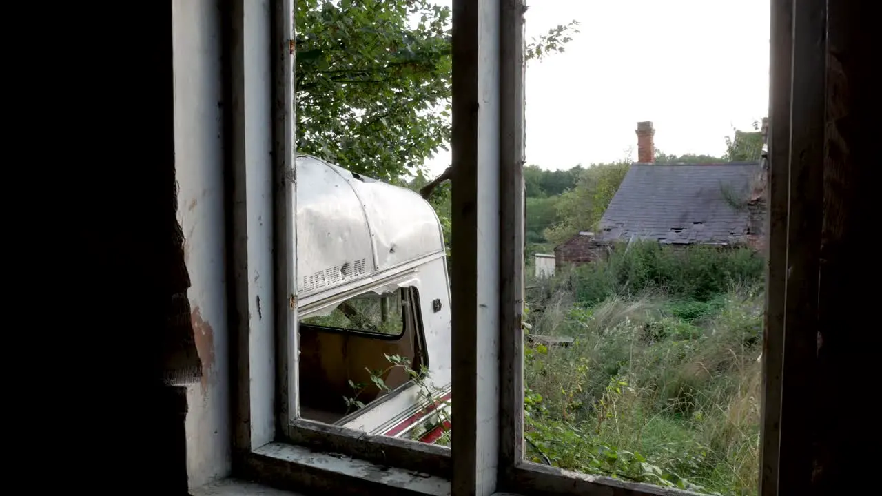 Panning shot through the window of an abandoned house