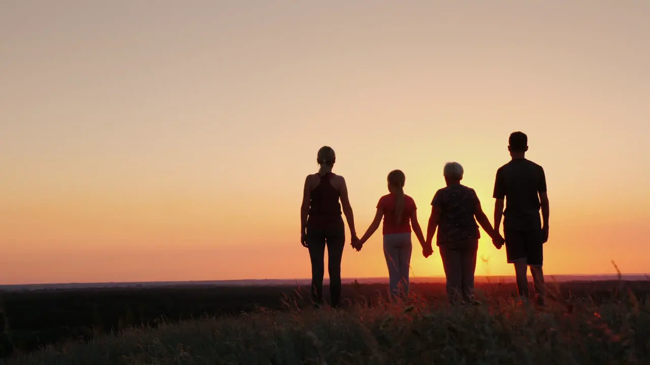 Active Healthy Family Grandmother With Daughter And Grandchildren Meet The Dawn Raise Their Arms Abo