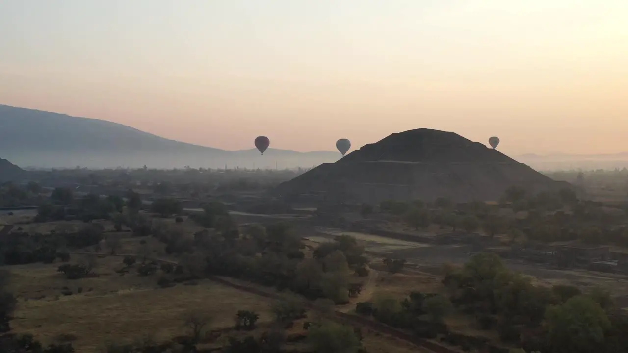 Drone footage of hot air baloon flying over Teotihuacan Mexico during foggy sunrise 4K