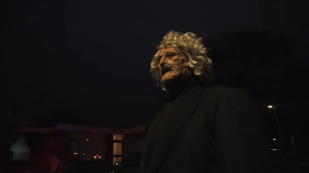 Scary grandpa walking in the street during halloween