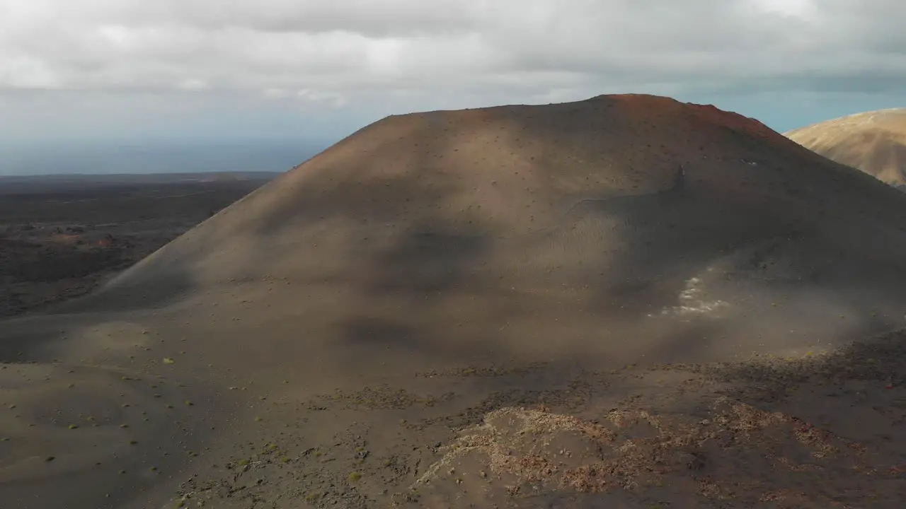 Aerial view of shadows of clouds passing on a volcanic hill