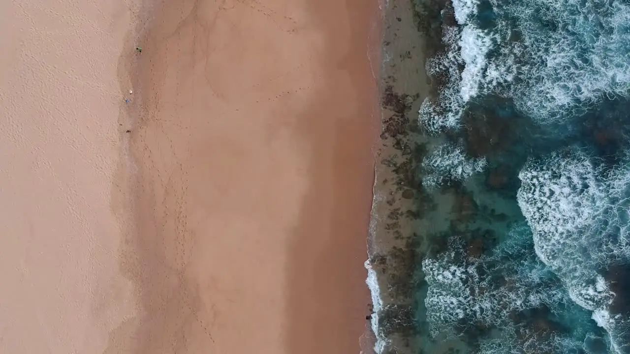 Arial view of beautiful shoreline birds-eye view flying along the coast