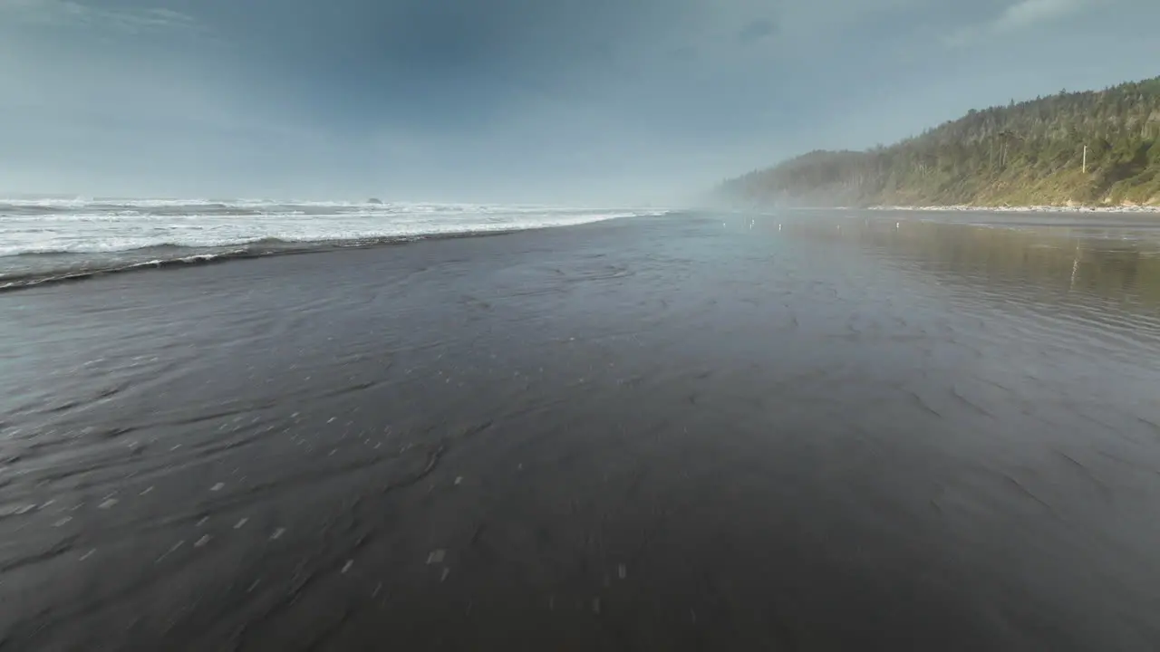 High speed aerial footage flying over coast line of pacific ocean in Washington state in America