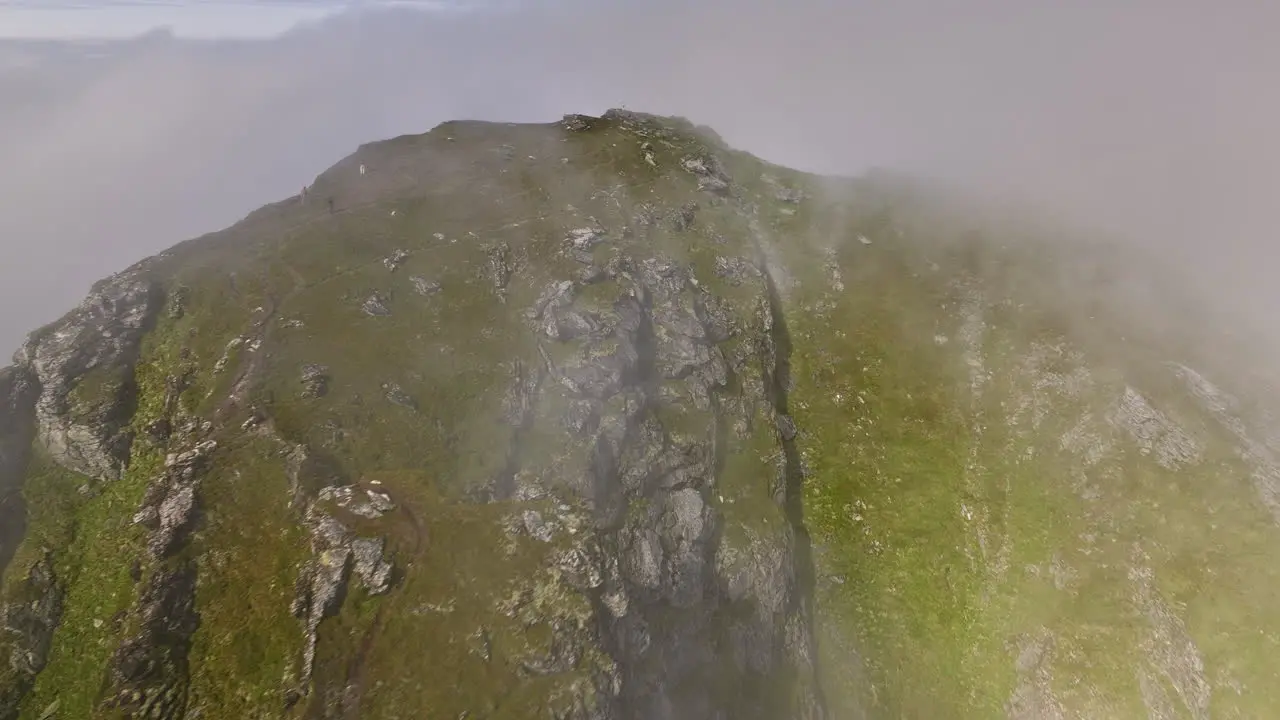 Stave Norway Aerial v20 birds eye view drone fly around craggy måtind mountain viewpoint capturing rocky details and coastal seascape surrounded by thick fog Shot with Mavic 3 Cine June 2022