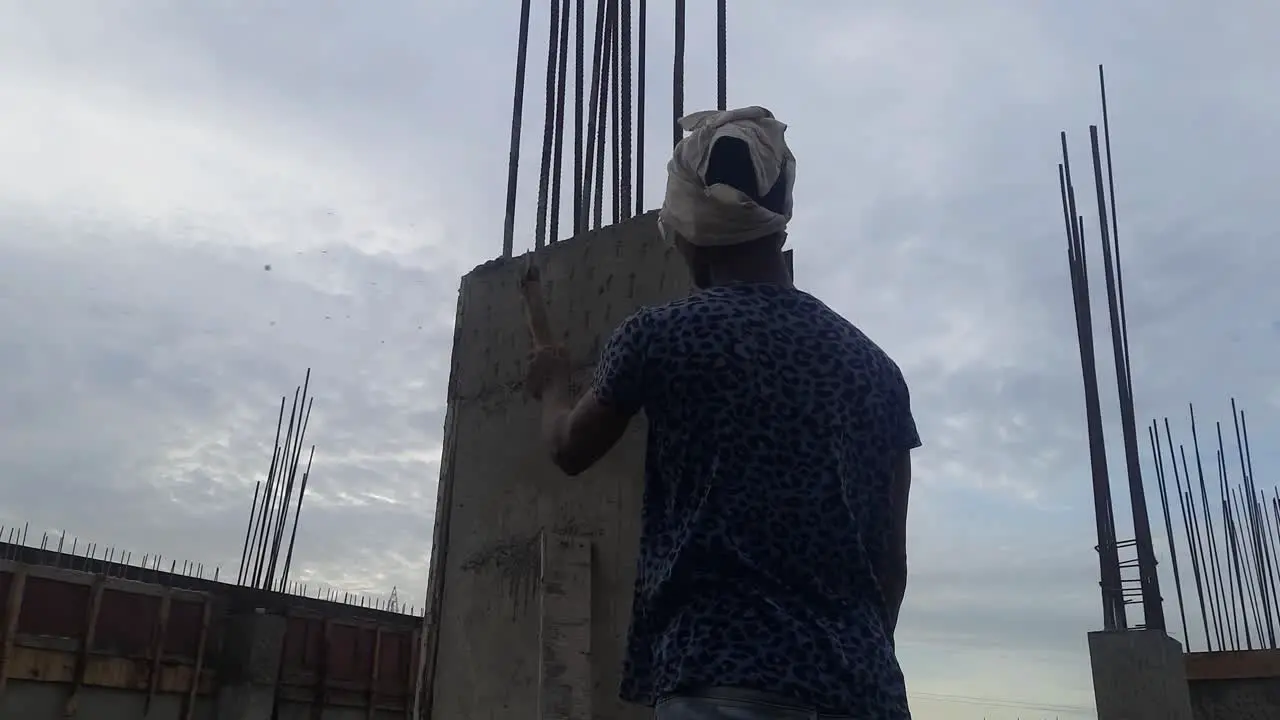 The Worker Is Notching The Concrete Column So That The Plaster Will Fit Properly