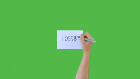 Woman Writing Loss and Downward Arrow on Paper with Green Screen