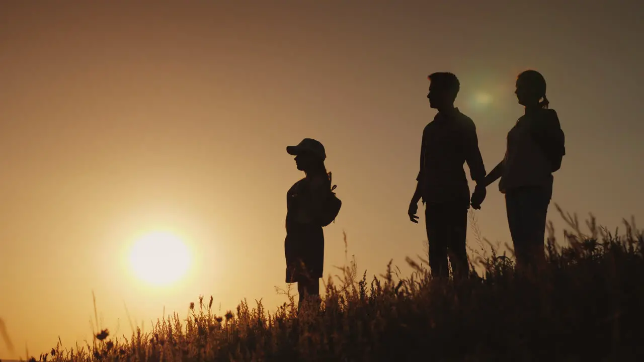 Silhouettes Of A Happy Family Together They Meet The Dawn In A Picturesque Place 4K Video